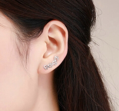 Sterling silver paw print climber earrings in silver (worn by model).