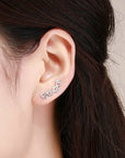Sterling silver paw print climber earrings in silver (worn by model).