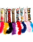 Handmade squirrel kicker toys in various colors and patterns with feather tails. Each one is stuffed with US grown, farm fresh catnip. Made in USA.