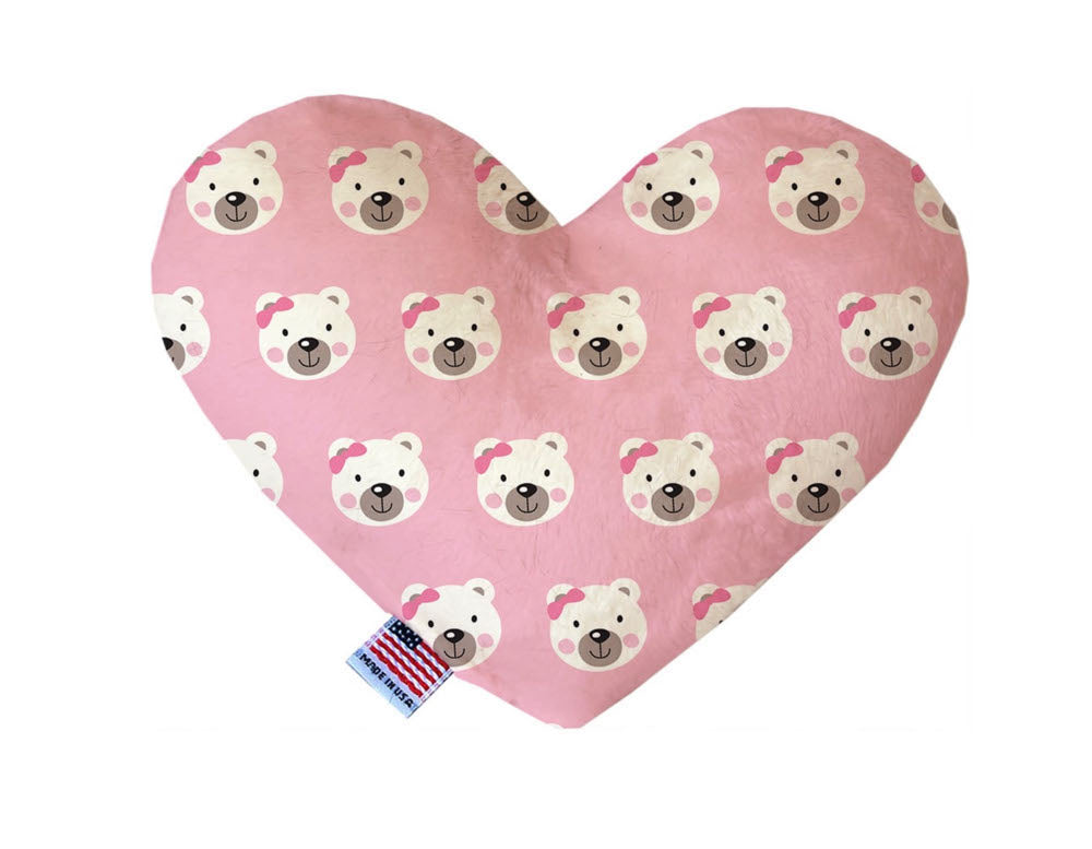 Heart shaped squeaker dog toy. Pink background with white bears wearing pink bows printed throughout. Made in USA label on bottom trim.