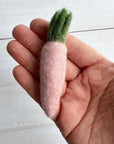 Someone holding a pink carrot felted wool cat toy in their hand to show size and scale.