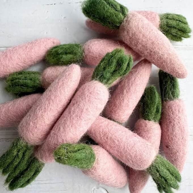 Grouping of pink carrot felted wool cat toys.