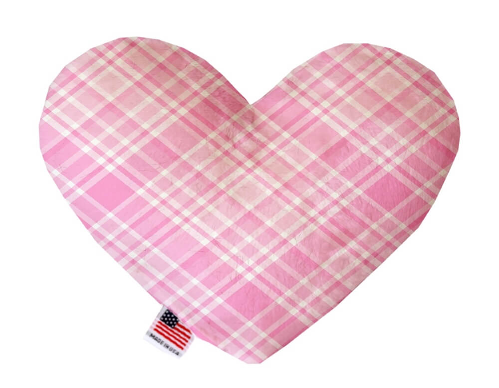 Heart shaped squeaker dog toy in pink and white plaid print. Made in USA label on bottom trim.