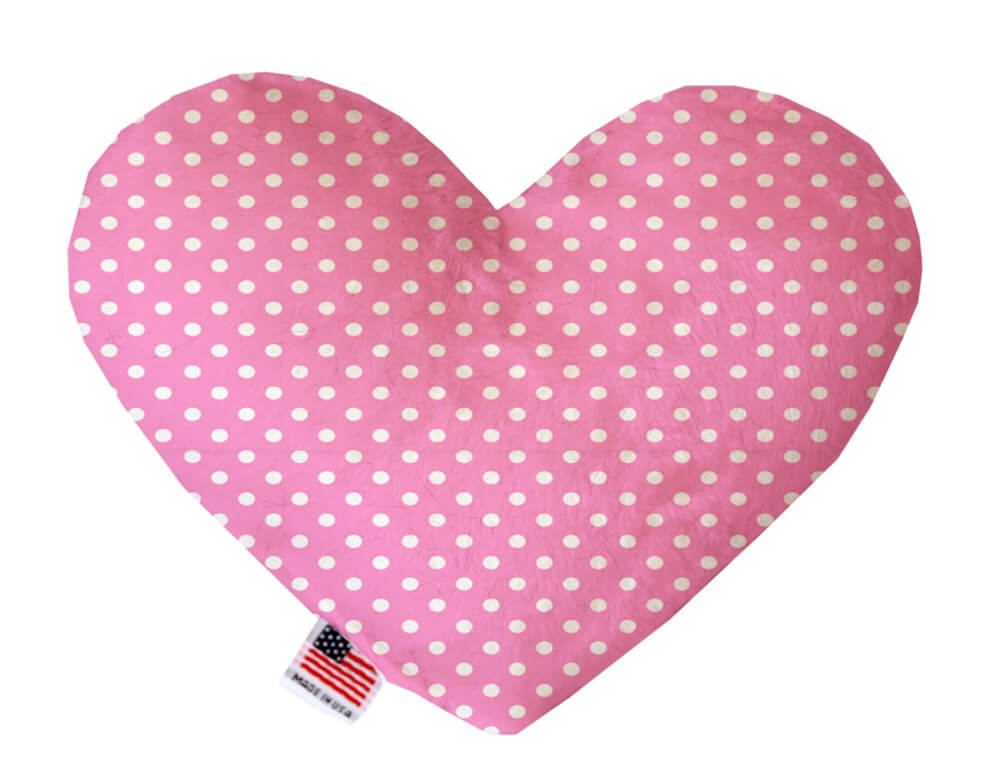 Heart shaped squeaker dog toy. Pink background with white polka dots. Made in USA label on bottom trim.