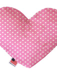 Heart shaped squeaker dog toy. Pink background with white polka dots. Made in USA label on bottom trim.