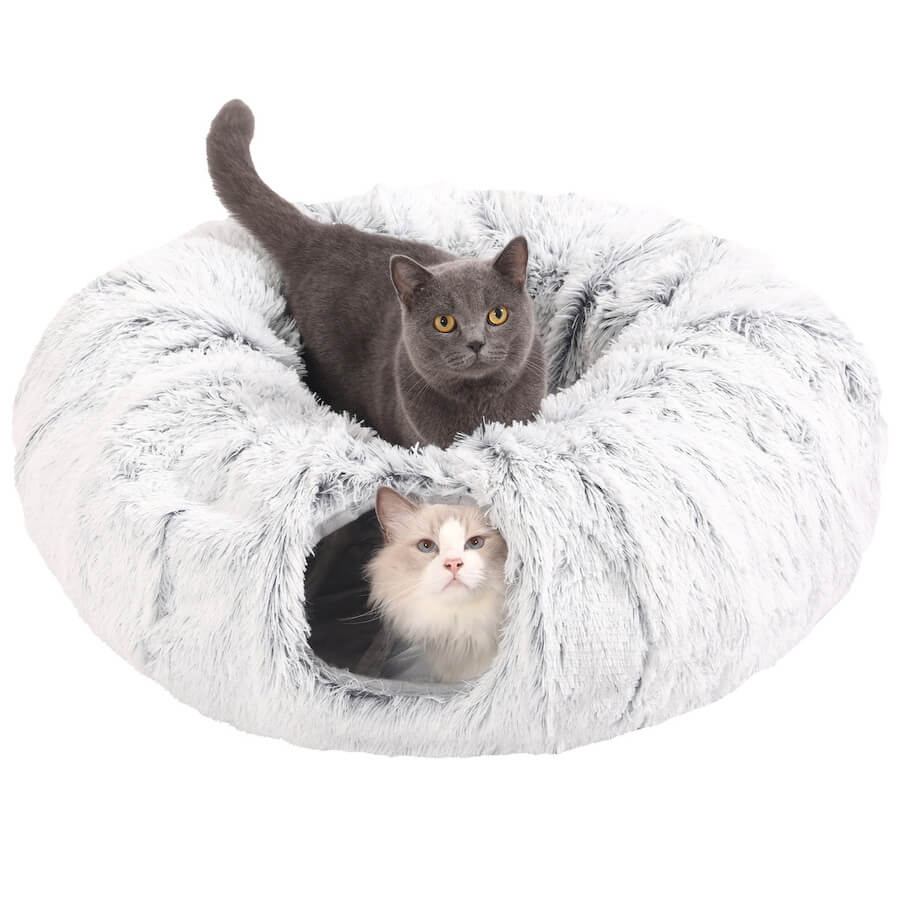 Two cats sitting in a plush gray donut tunnel.