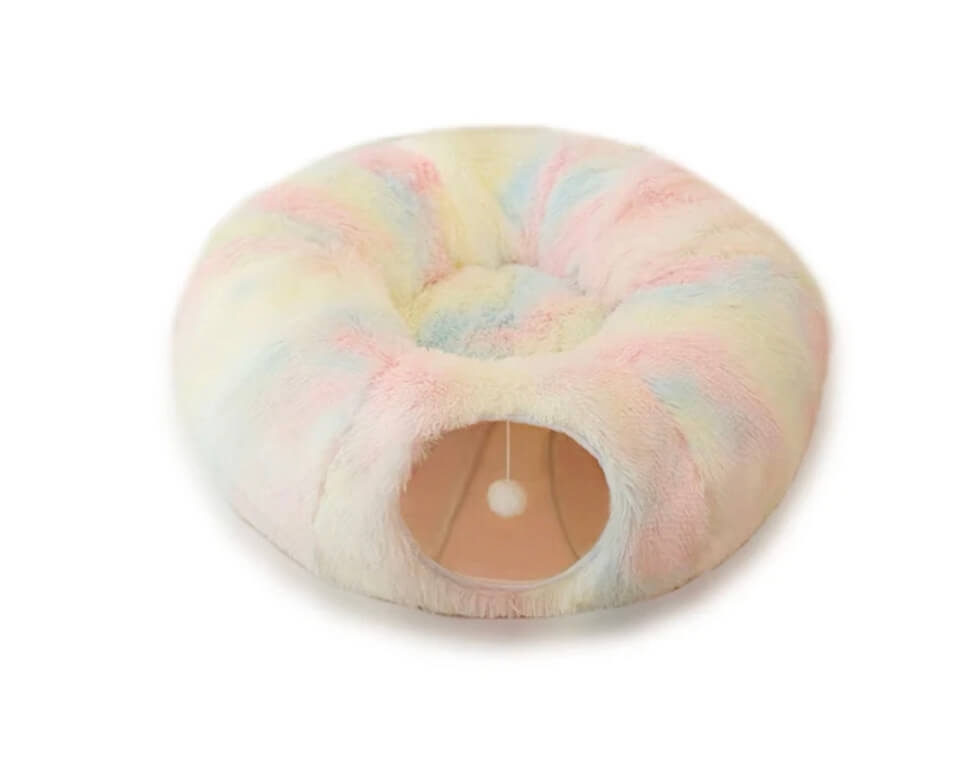 Stock photo of plush rainbow donut tunnel and cat bed.