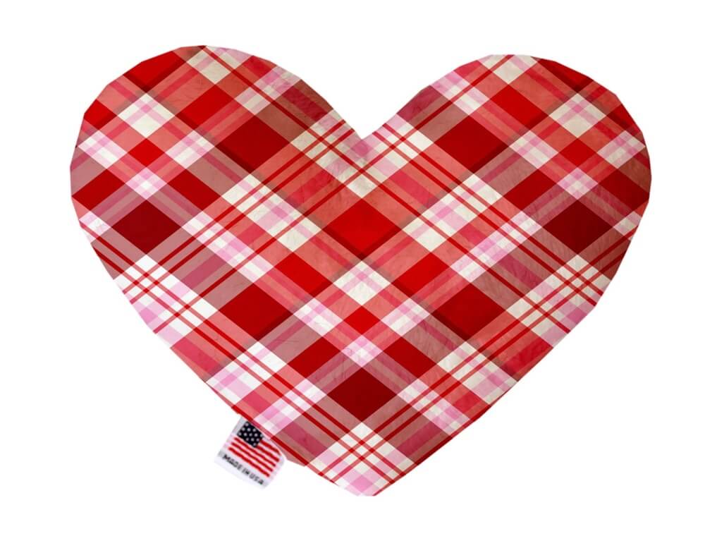Heart shaped squeaker dog toy in red, pink and white plaid print. Made in USA label on bottom trim.