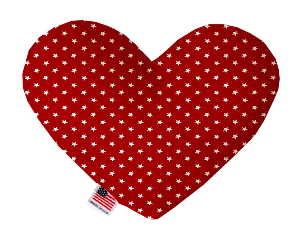 Red heart shaped squeaker dog toy with white stars printed throughout. Made in USA label on bottom trim.