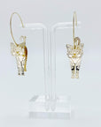 Metallic rose gold cat hoop earrings.