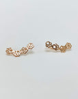 Sterling silver paw print climber earrings in rose gold.
