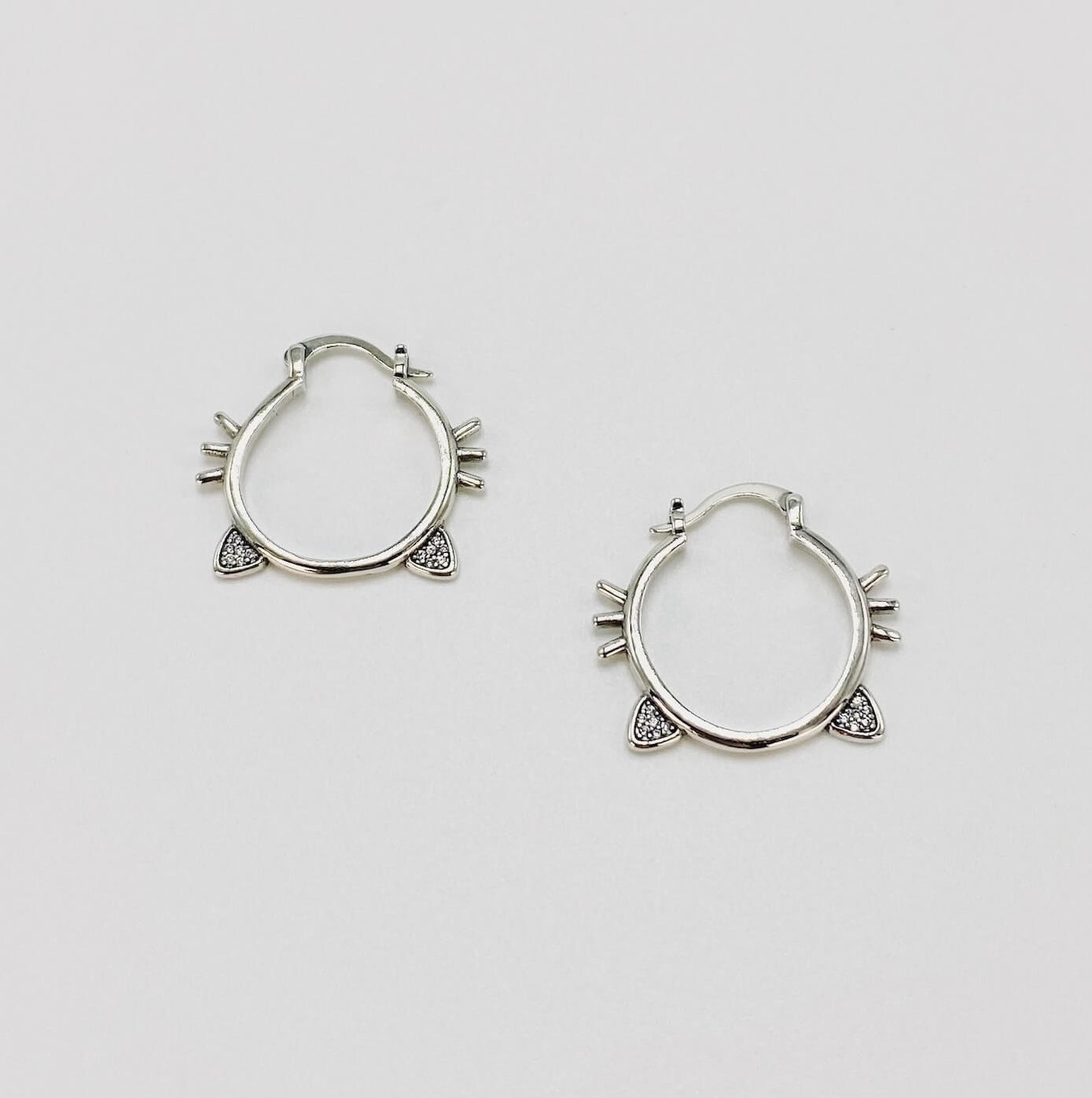 Sterling silver hoop earrings with cat ears and whiskers.