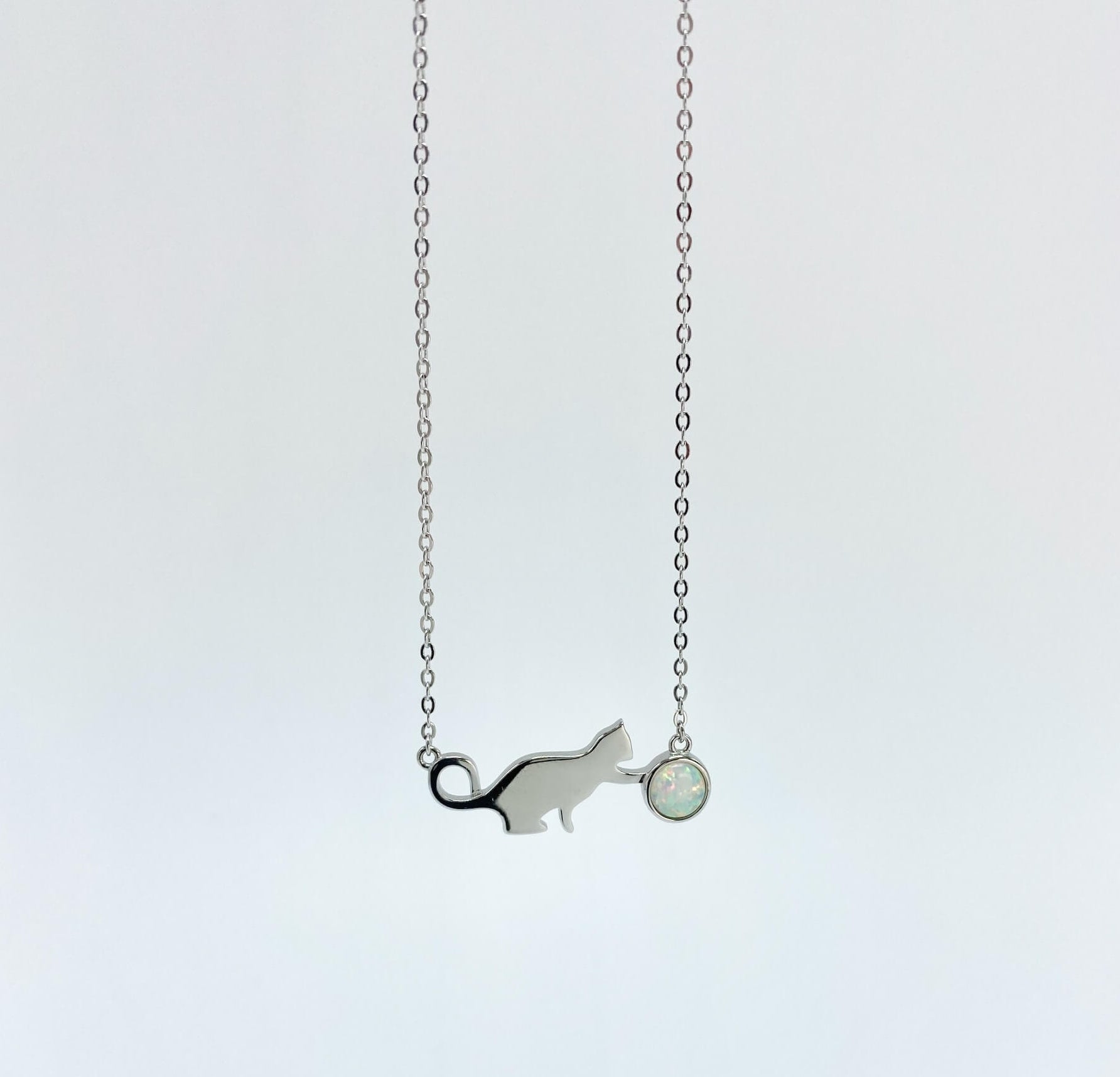 Sterling silver necklace with cat and opal charm.