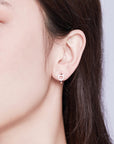 Sterling silver cubic zirconia cat huggie earrings (worn by model).
