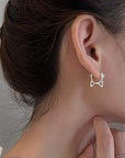 Sterling silver cat head hoop earrings (worn by model).