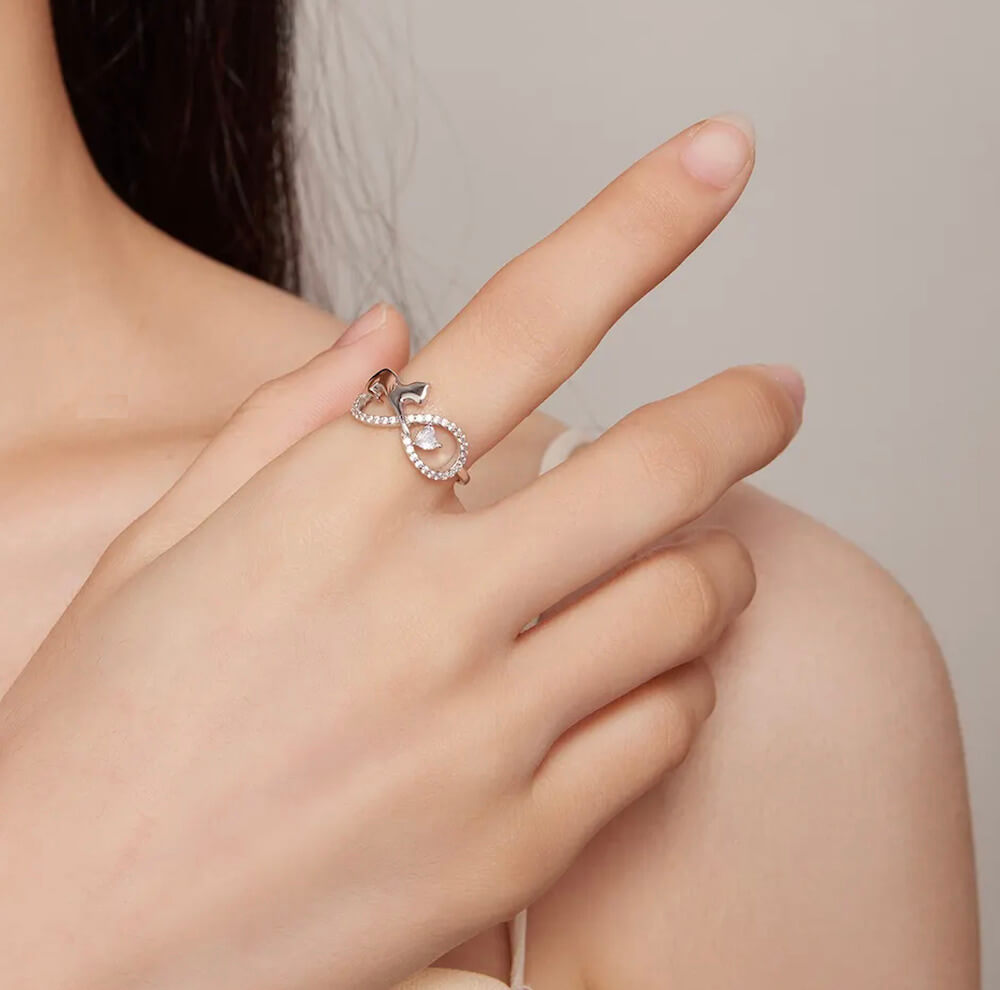 Sterling silver infinity cat ring with cubic zirconia gemstones in a pave setting (worn by model).