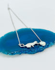 Sterling silver necklace with cat and opal charm.