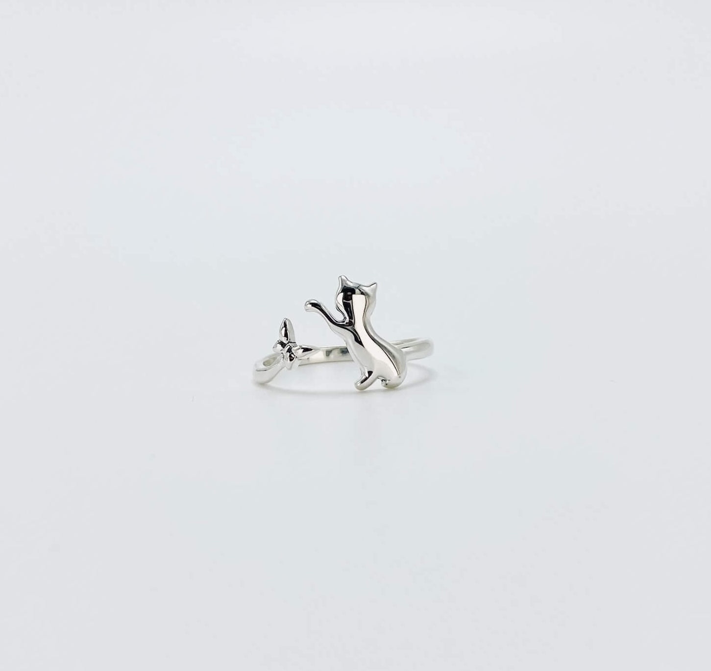 Sterling silver ring that features a cat chasing a butterfly.