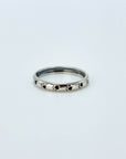 Sterling silver band ring with black enameled paw prints.