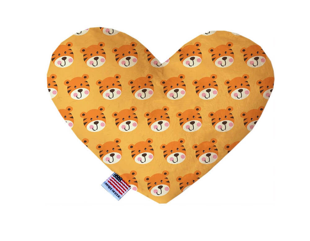 Heart shaped squeaker dog toy. Orange background with smiling tigers printed throughout. Made in USA label on bottom trim.