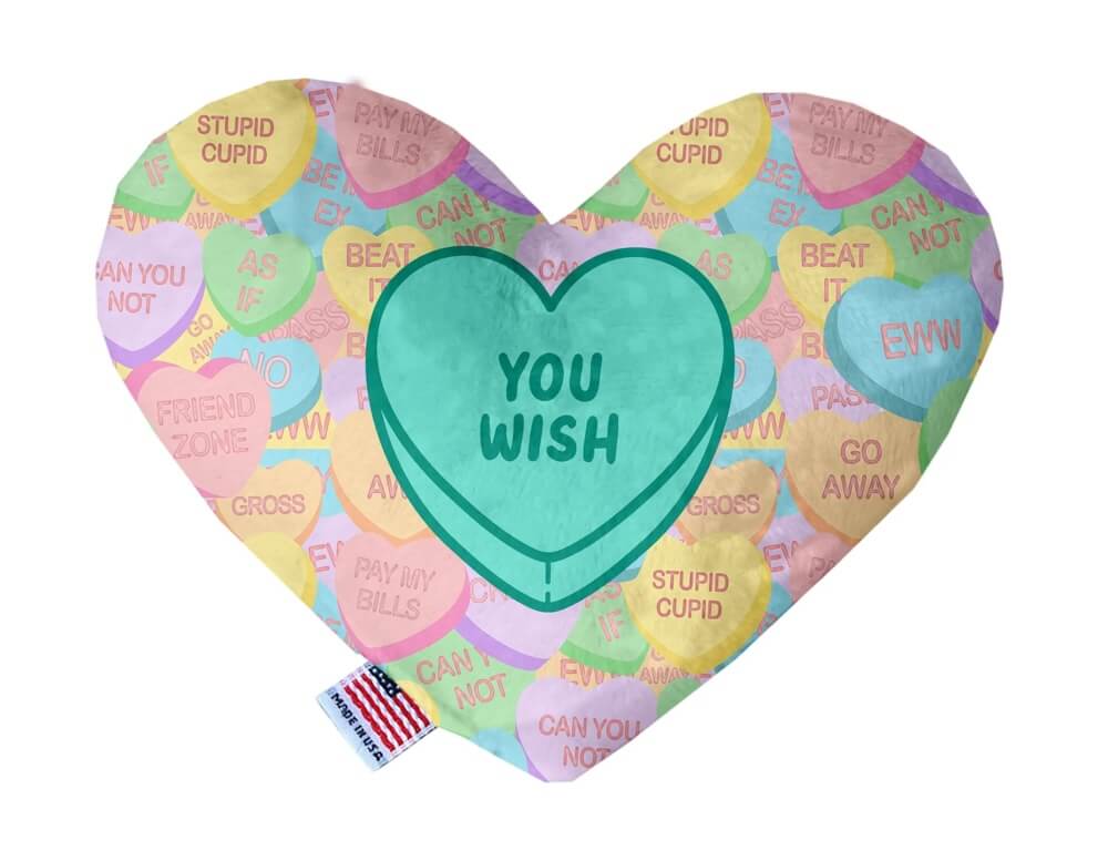Heart shaped squeaker dog toy. Multicolored Valentine's Day candy heart background with 'You Wish' heart in the center. Made in USA label on bottom trim.