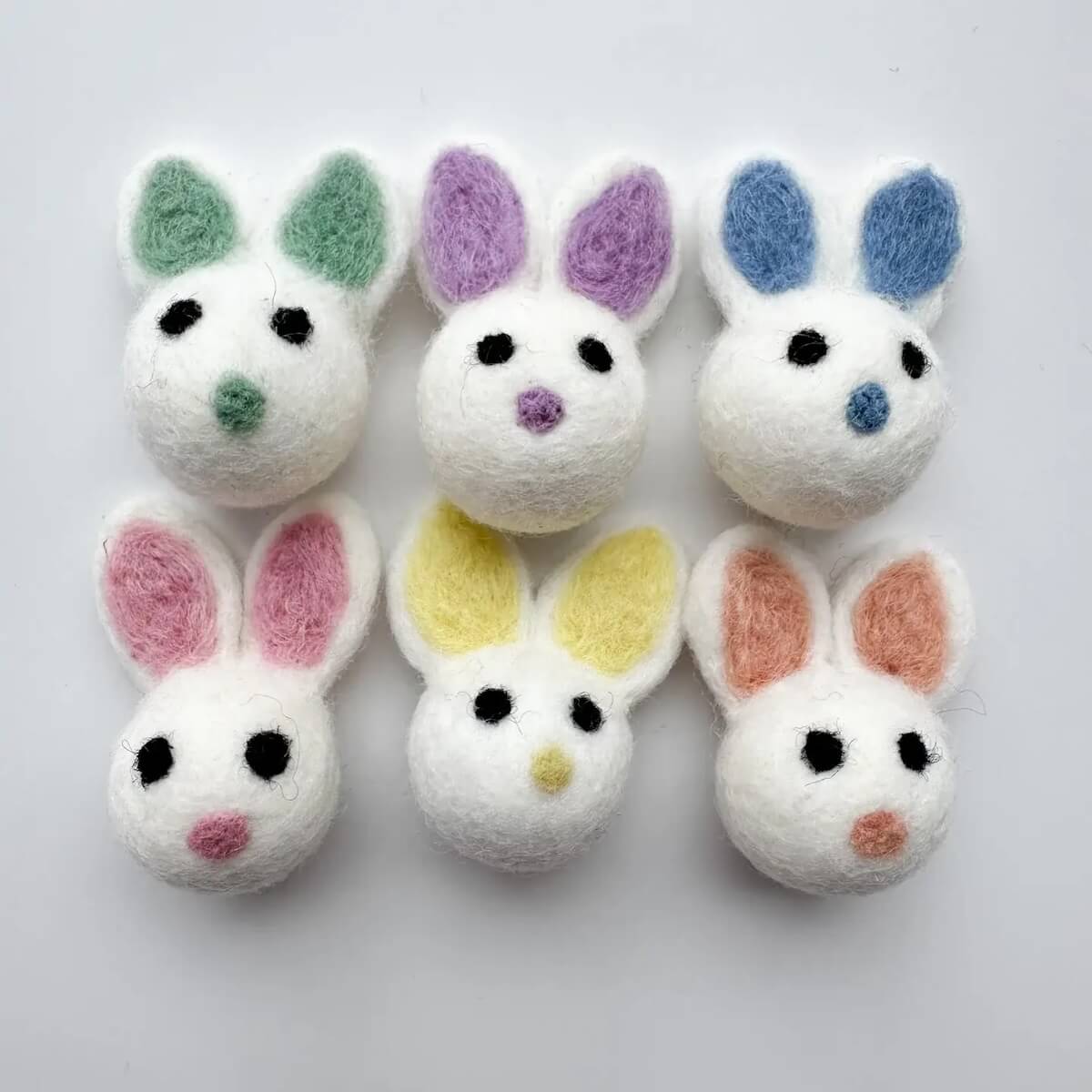 A grouping of six easter bunny felted wool cat toys.