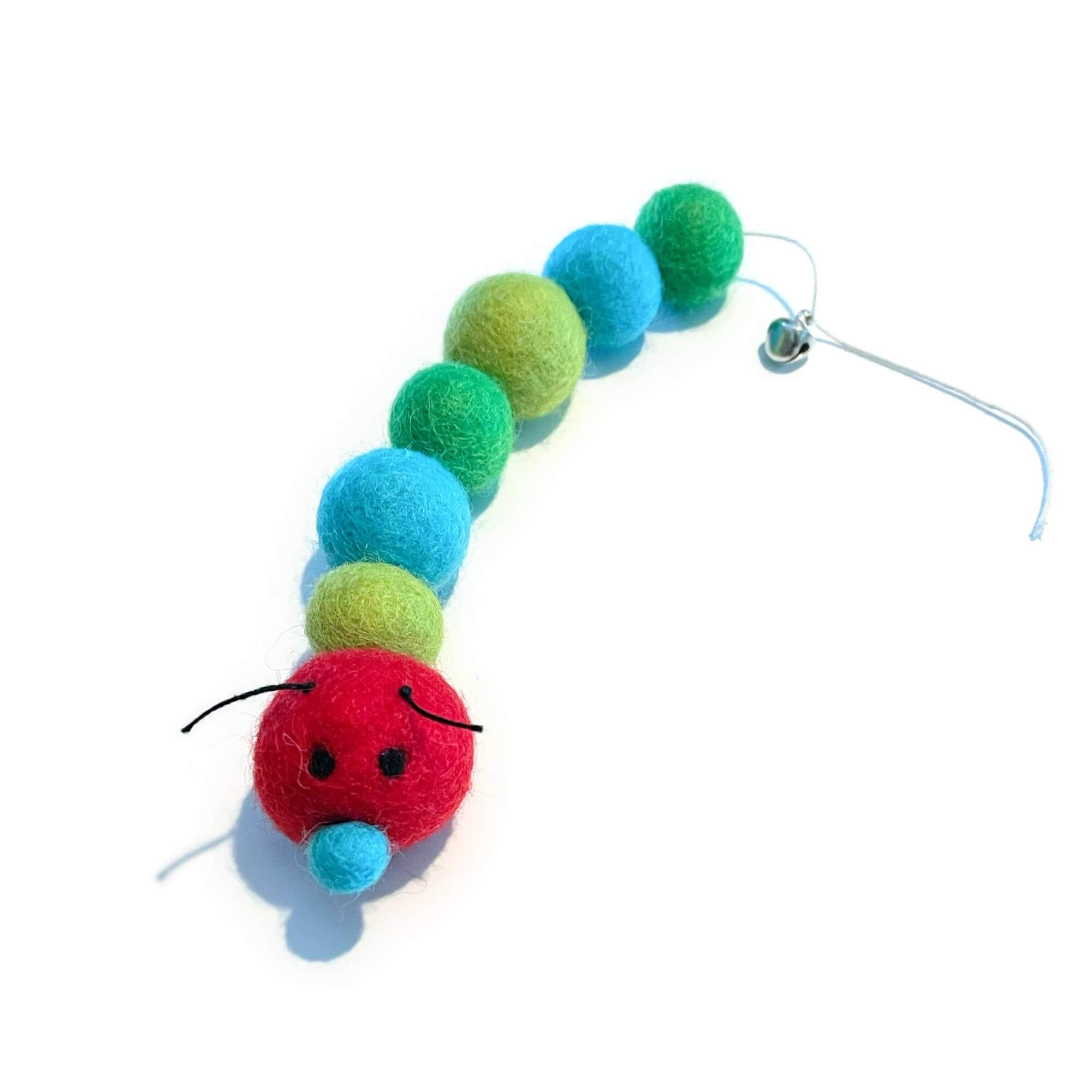 Organic wool caterpillar cat toy in red, blue & green tones. Has bell at the end of its tail.