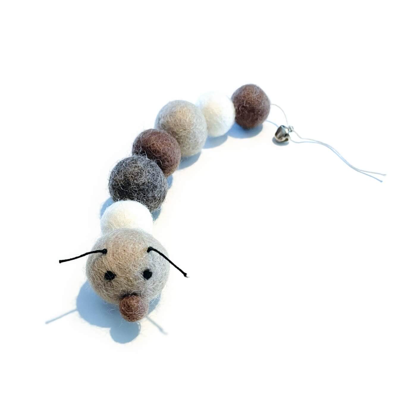Organic wool caterpillar cat toy in neutral tones (brown, white, &amp; charcoal). Has bell at the end of it&#39;s tail.