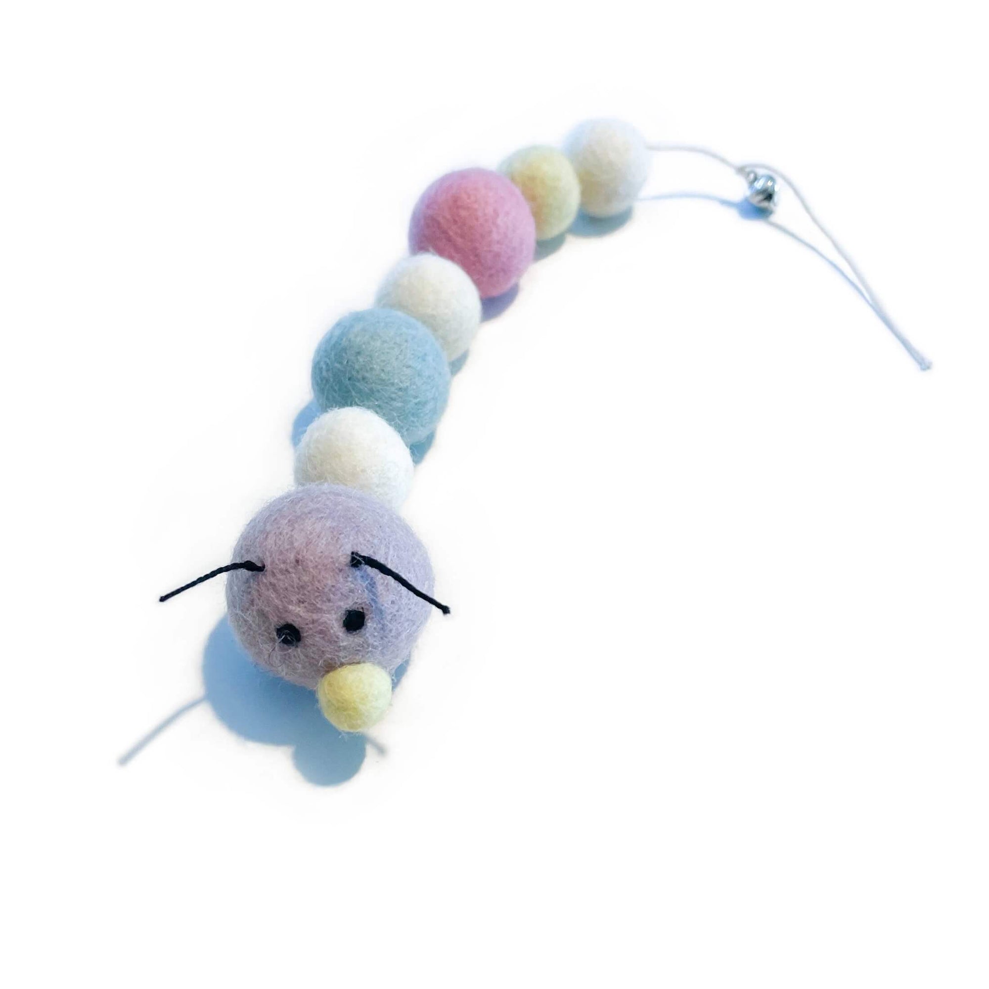 Organic wool caterpillar cat toy in pastel tones (purple, white, blue, pink & yellow). Has bell at the end of its tail.
