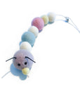 Organic wool caterpillar cat toy in pastel tones (purple, white, blue, pink & yellow). Has bell at the end of its tail.