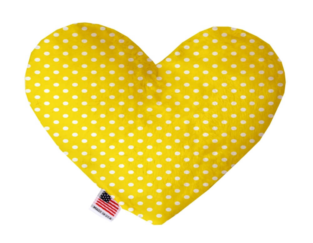 Heart shaped squeaker dog toy. Yellow background with white polka dots. Made in USA label on bottom trim.